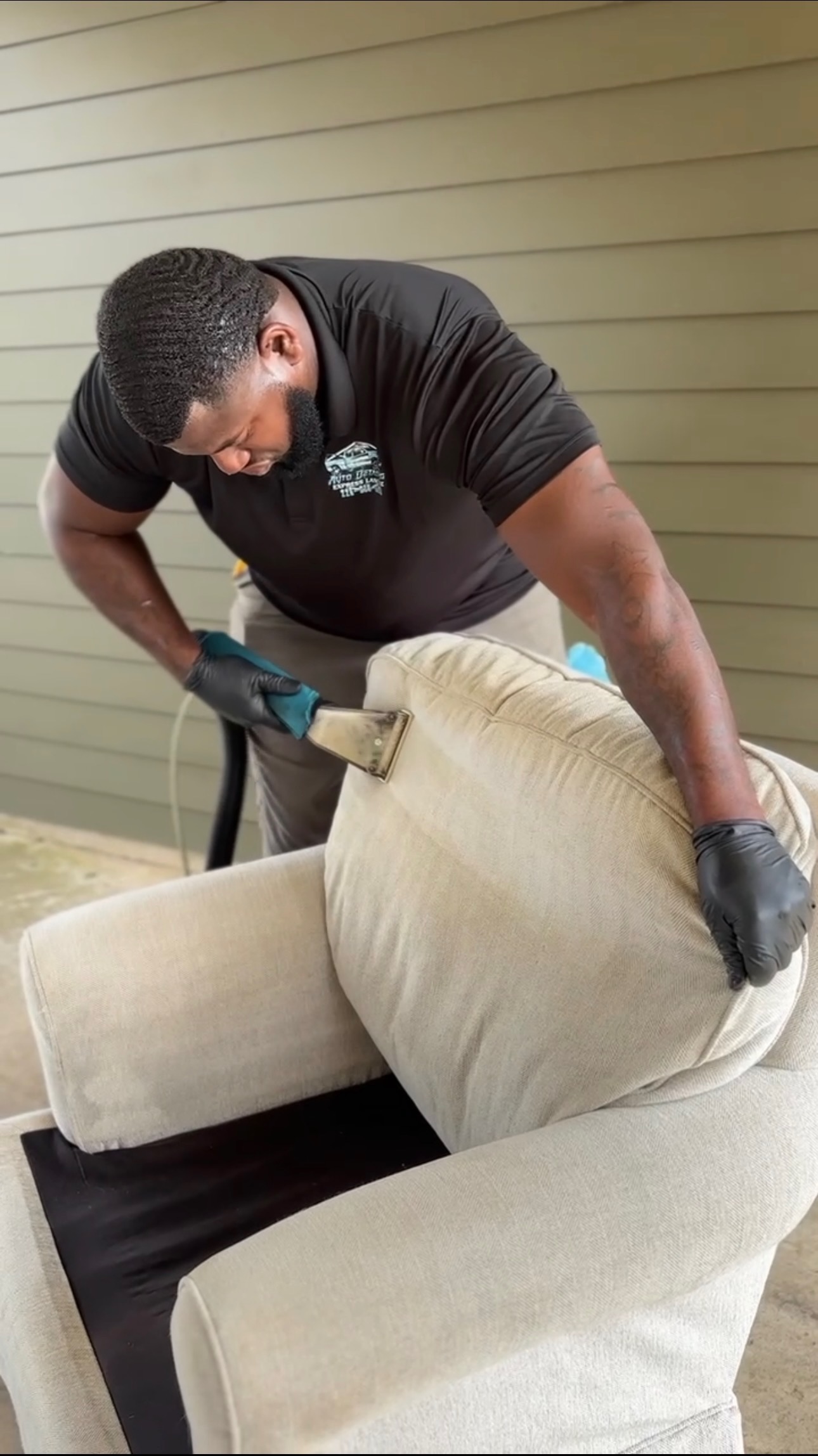 Technician deep cleaning a sofa during mobile furniture upholstery cleaning in Baton Rouge