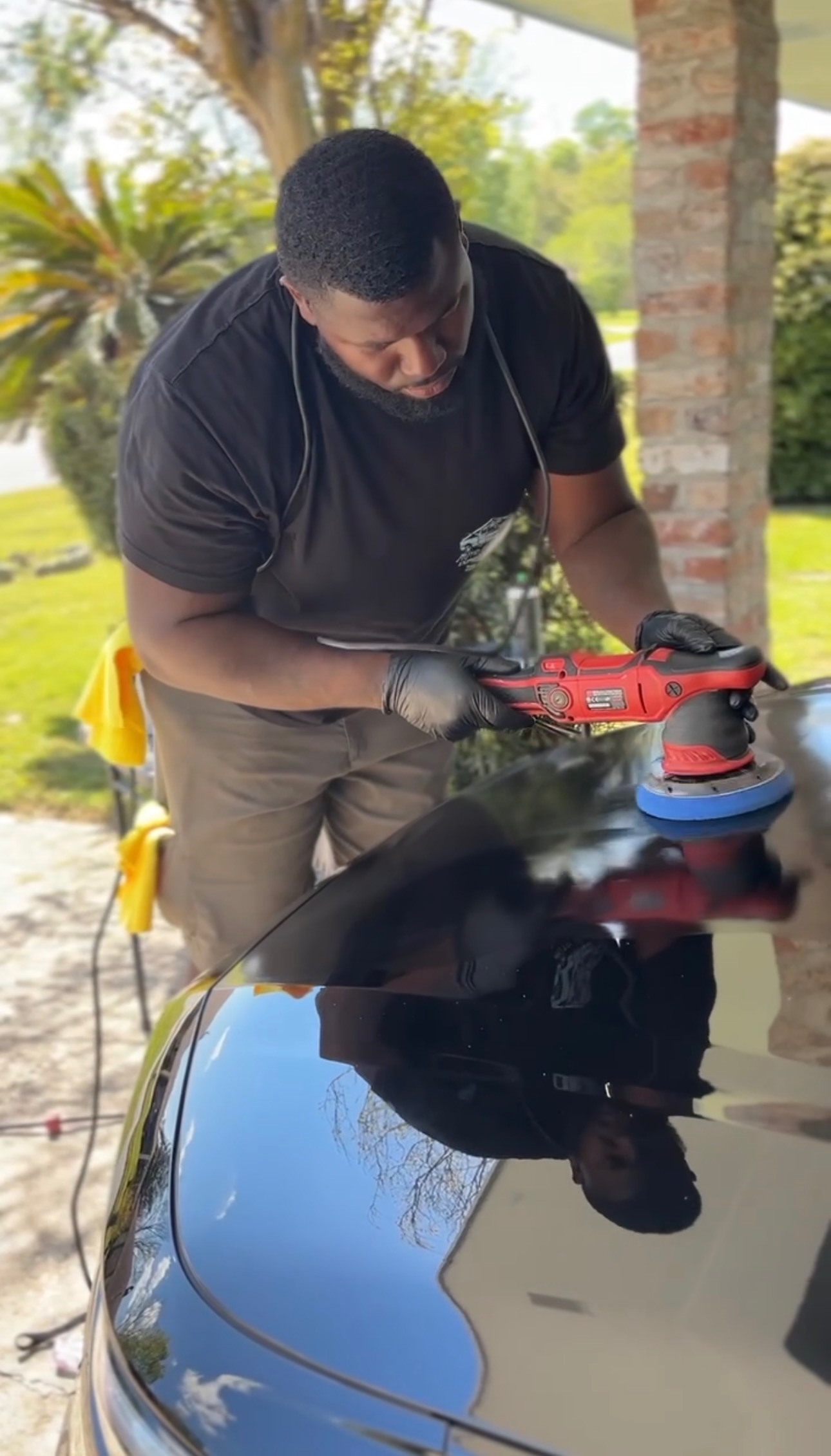 Professional mobile detailer performing paint enhancement polishing on a vehicle in Baton Rouge, LA