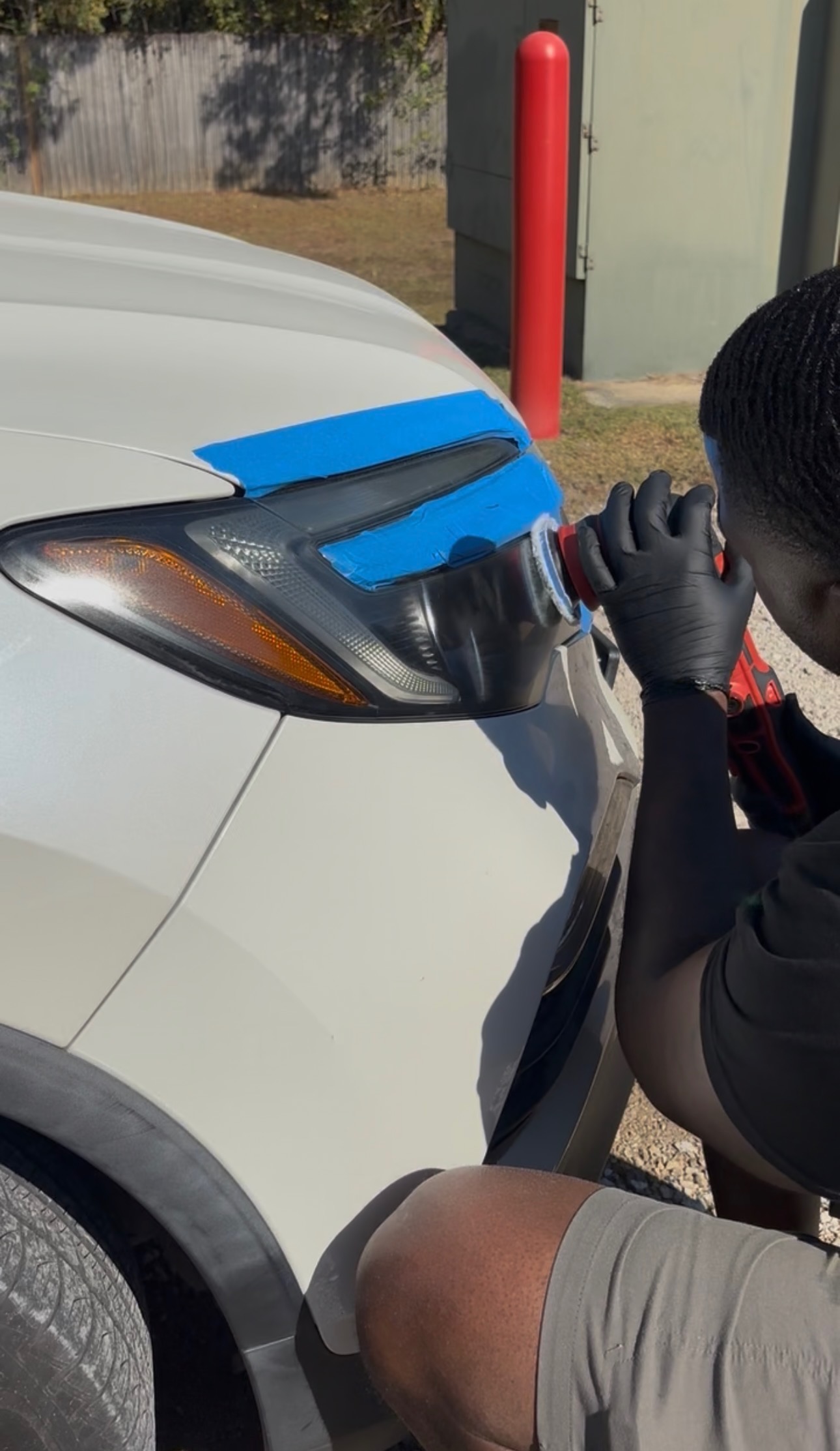 Auto Detailing Express Lane technician polishing a cloudy headlight during mobile headlight restoration in Baton Rouge, LA